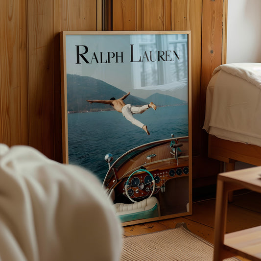 Framed poster of man diving from vintage boat on lake, leaning against wooden wall in bedroom