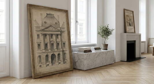 Large architectural sketch poster in vintage frame leaning against wall in minimalistic living room interior with marble cabinet and potted plant, old money aesthetic decor.
