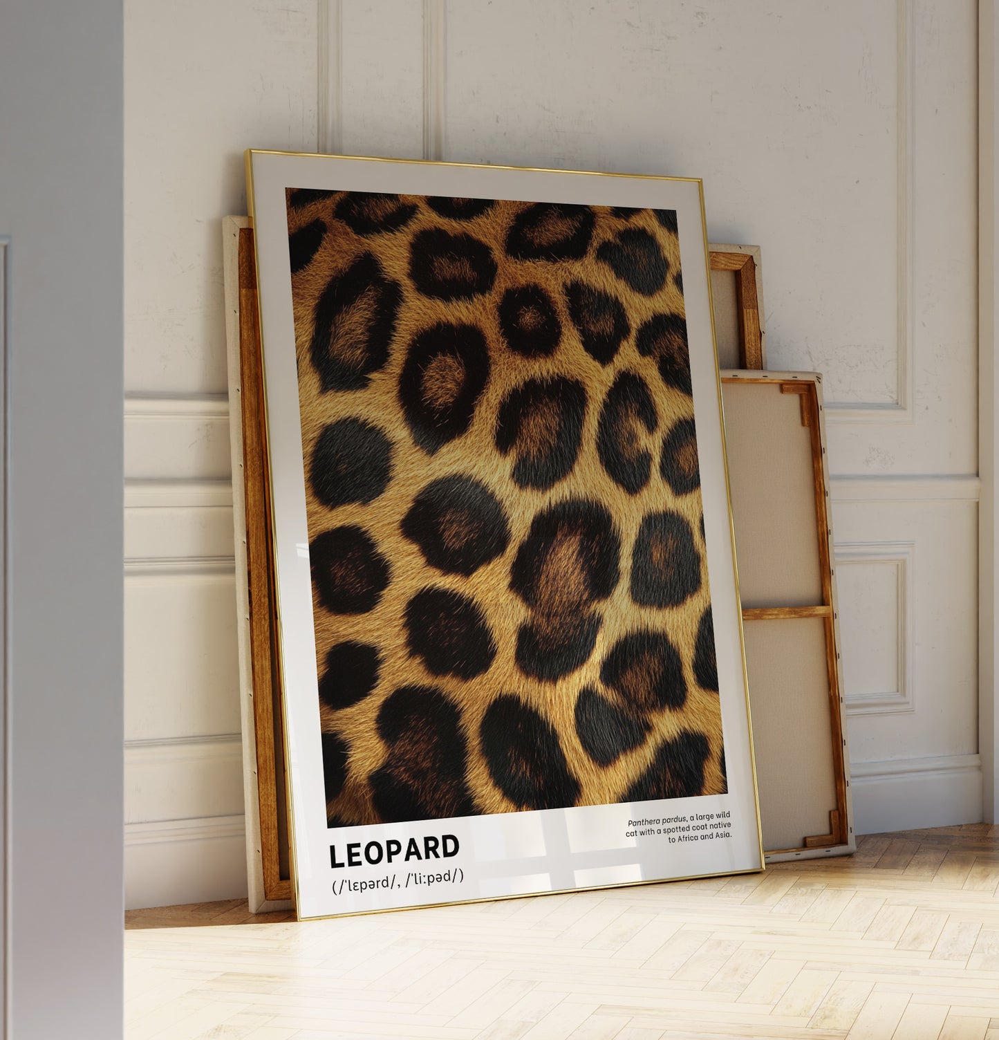 Framed poster with leopard print design leaning against a wall.
