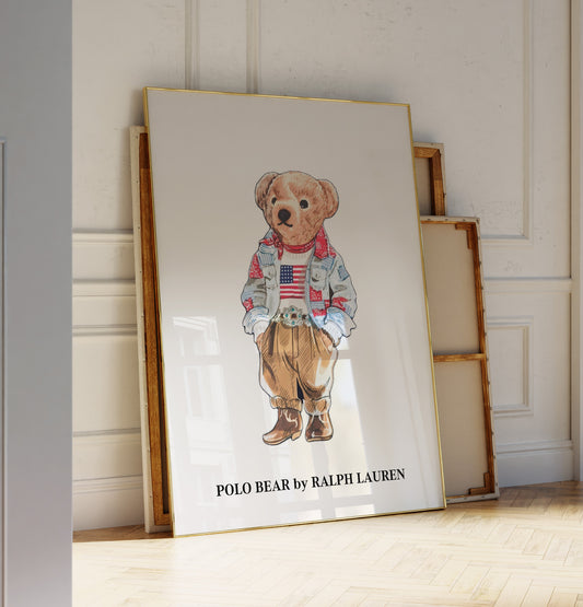 Framed artwork of a teddy bear with an American flag shirt, displayed against a white wall.