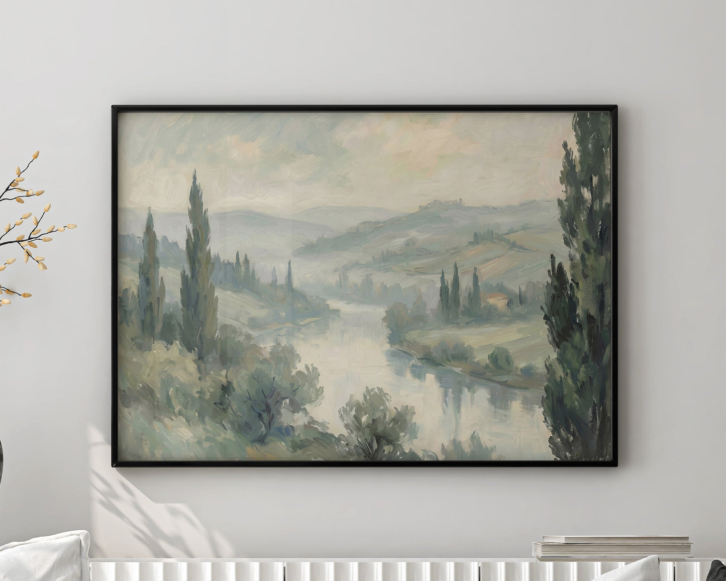 Living room with a white sofa, decorative pillows, and a framed landscape painting on the wall.