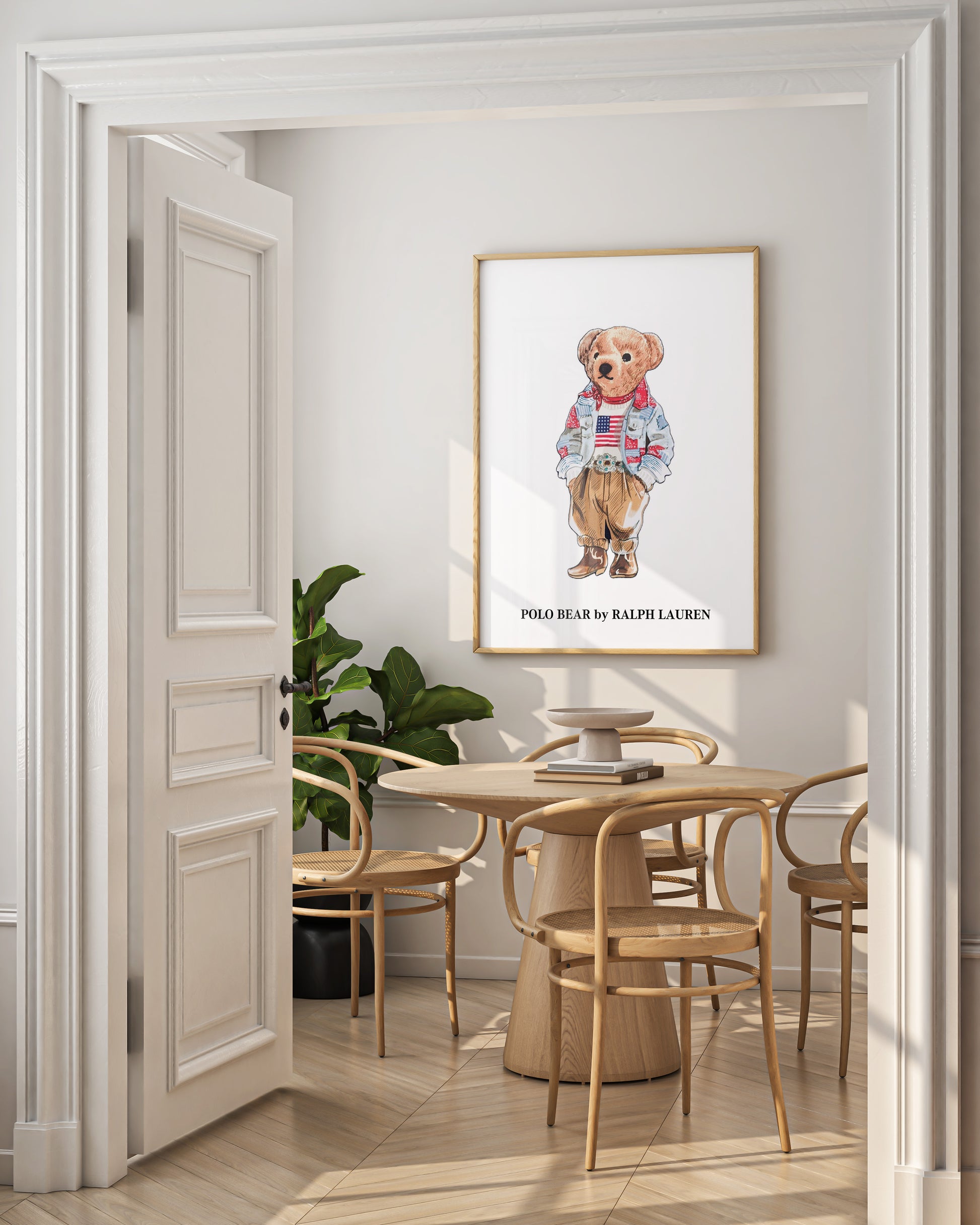Dining room with a framed picture of a bear wearing a sweater on the wall.