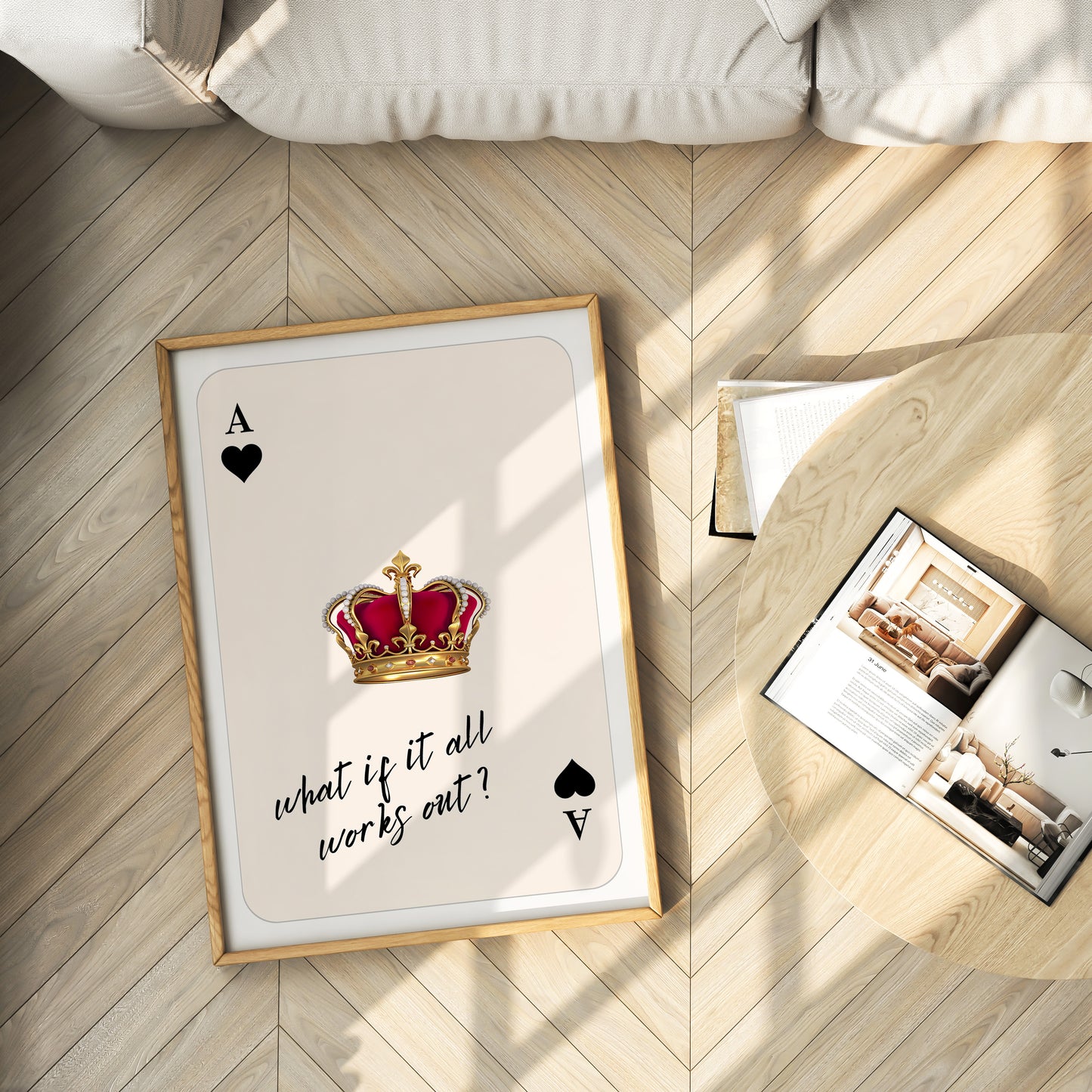 Framed playing card with a crown and text on a wooden floor