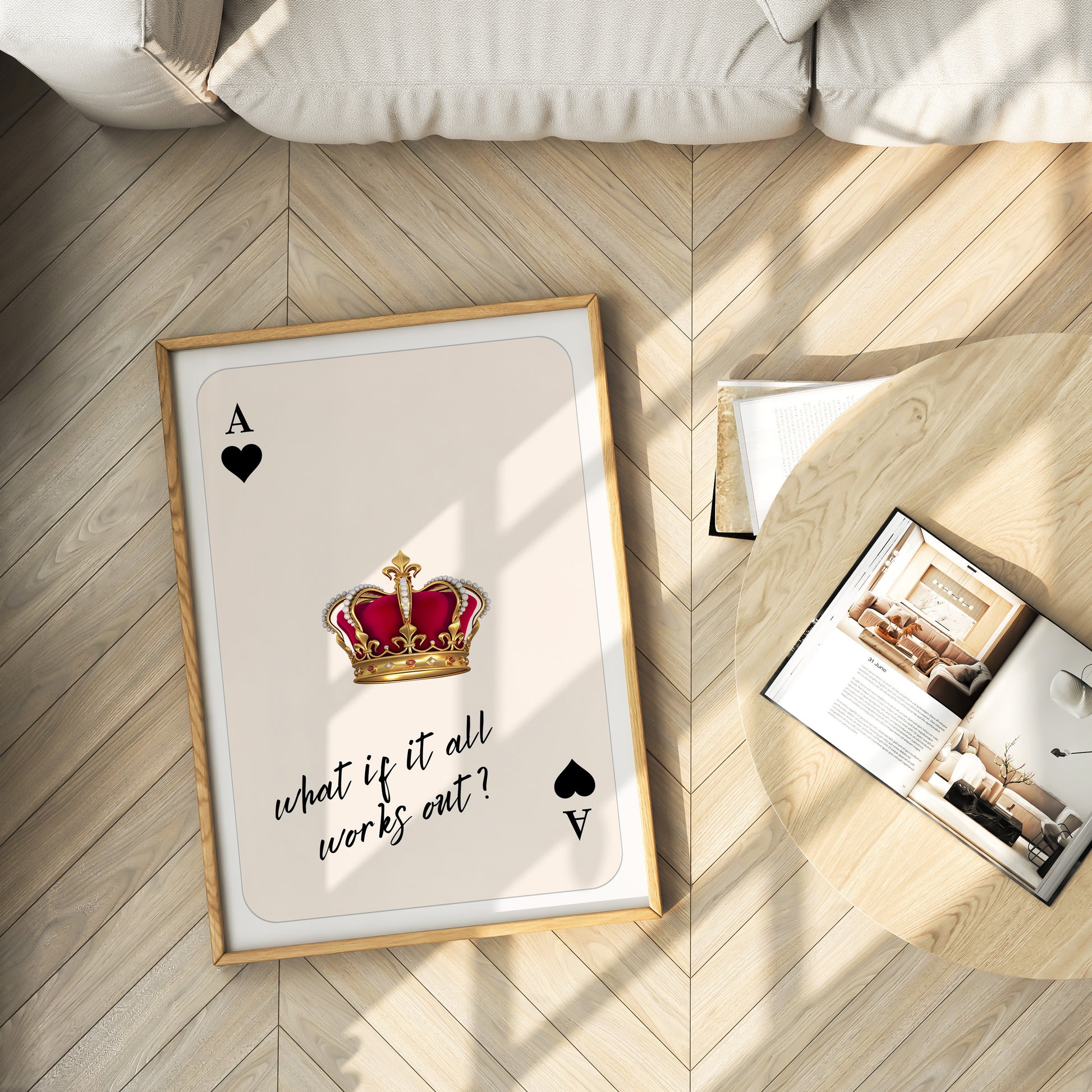 Framed playing card with a crown and text on a wooden floor