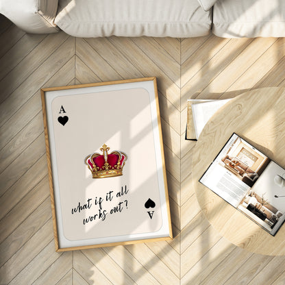Framed playing card with a crown and text on a wooden floor